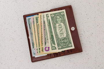Open Leather Wallet Filled with US Dollar Banknotes