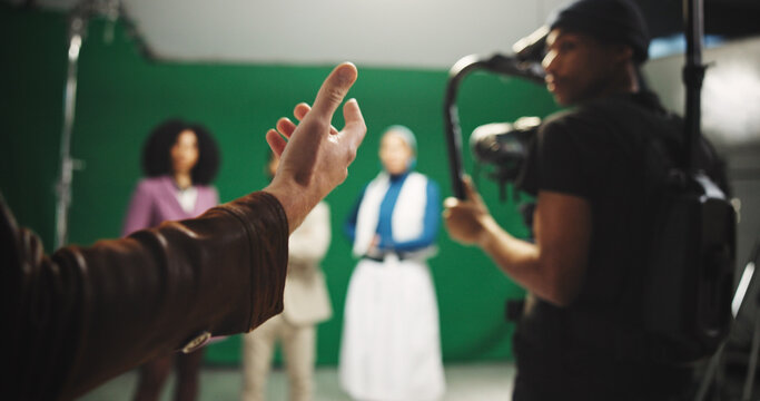 Director, hands and instructions to crew on set for creative advice, cast direction and guidance. Videography, filming team and people with green screen for movie production and performance feedback