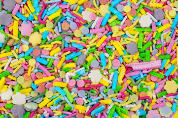 Unicorn confetti shapes sugar cake decoration background texture