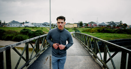 Running, bridge and man in city for fitness, marathon training and workout for challenge. Sports,...