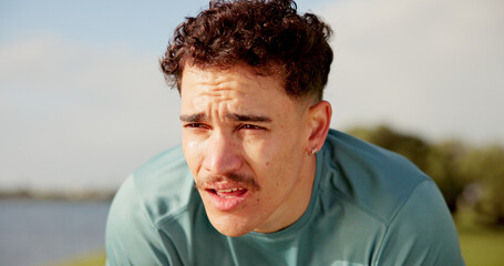 Tired, athlete and man for fitness outdoor from running, sports exercise and workout break....