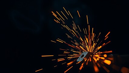 Abstract close-up of glowing orange sparks in a dark industrial setting, showcasing metalwork artistry.