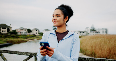 Thinking, fitness or woman with phone on bridge for exercise break, training app or monitor...