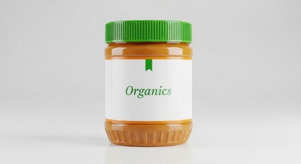 A jar of organic peanut butter with a green lid on a white background