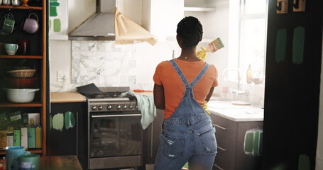 DIY, ideas and paintbrush with black woman in kitchen of new house for maintenance from back....