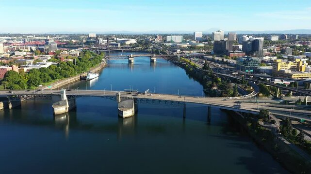 4k high quality aerial drone video footage showcasing a morning traffic on Hawthorne, Morrison and Burnside bridges, across Willamette river in Downtown Portland, Oregon, blue sky