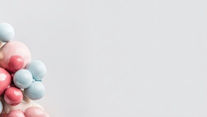 Pastel-colored spheres clustered in a triangular shape against a light gray background