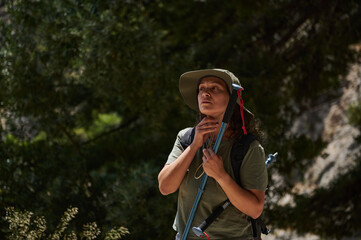 Woman Exploring the Outdoors with Hiking Gear in a Forest Setting
