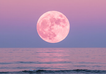 A moonrise or moonset over a calm body of water (likely an ocean or large lake) during twilight hours