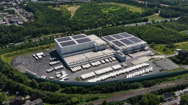 Aerial view of a logistics and road transport center in Bochum, Germany, with trucks and solar roofs