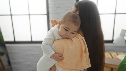 Mother holding baby girl in cozy home bedroom, showing bond, love and warmth indoors, with natural...