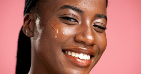 Portrait, facial treatment and black woman with serum, skincare and beauty for healthy skin or glow. Studio background, oil and person with cosmetics for shine, anti aging and wellness for face