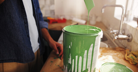 DIY, paint can and renovation with person in kitchen of apartment for development or maintenance....