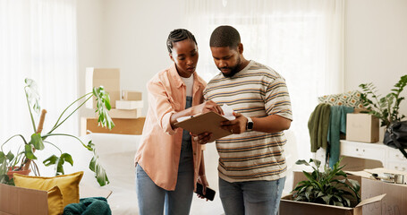 Boxes, clipboard and moving house with black couple in living room for planning or relocation. Checklist, conversation and real estate with people in home for discussion, packing or property task