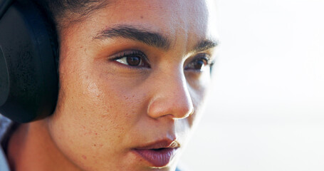 Headphones, woman thinking or runner with sky space for training, workout or exercise. Outdoor, resting or sports girl athlete on break for streaming radio, music mockup or fitness podcast to relax