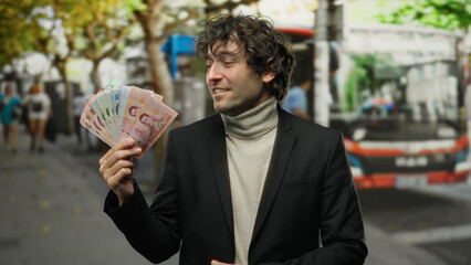 Man smiling holding thai banknotes at a street bus stop in thailand, dressed in coat enjoying...