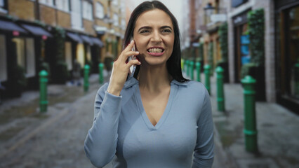 Hispanic woman on phone expressing emotions in outdoor urban setting with street views, showcasing...