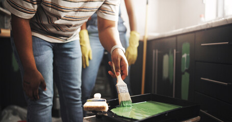 DIY, hand and paintbrush with person in kitchen of apartment for home improvement or renovation....
