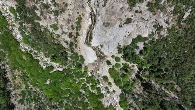 Aerial Little Cottonwood Canyon granite waterfall Utah overhead. Wasatch mountain range central utah, outside salt lake city, utah. winter summer recreation. landscape scenic and rugged. cliff.