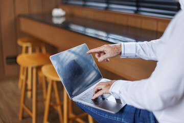 Cropped image of business man hand working laptop computer in the office 