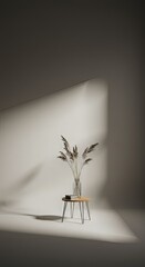 Dried pampas grass in glass vase on small wooden stool, bathed in sunlight, minimalist studio setting.