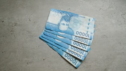 Chilean banknotes of 10000 pesos fanned out on a concrete surface showcasing the intricate design...