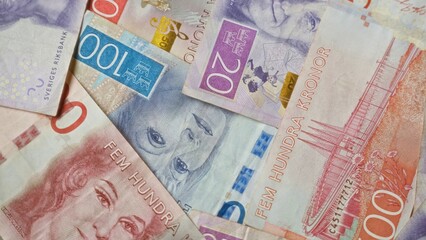 Swedish banknotes featuring krona currency in various denominations are spread out, highlighting...