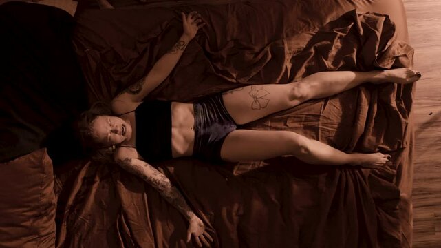 demon possessed woman writhes on a bed during exorcism