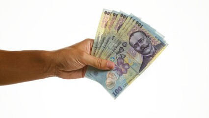 Hand holding romanian lei banknotes on isolated white background, showcasing money and currency...