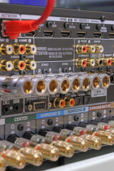 Rear panel of a high-quality AV receiver with multimedia connections for connecting speakers, analog and digital signals. 