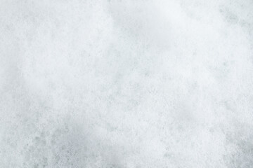 The texture of the white white surface of the detergent, spa cosmetic product. the background is white fluffy foam. Layout for design, copy of space.
