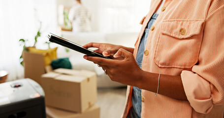 Tablet, moving and hands of woman in new house for research on renovations, interior design or...