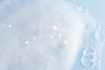 large transparent bubbles on the foam surface of detergent or cosmetics. white foam surface. texture.
