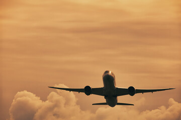 Airplane in the sky, over the cloudy sky , vacation holidays travel tourism

