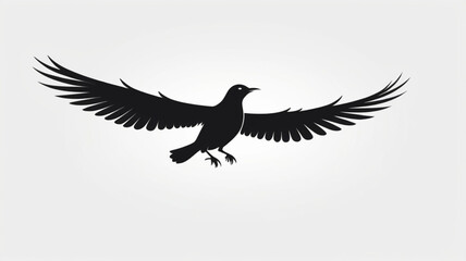 Obraz premium Silhouette of a black bird soaring with outstretched wings against a white background.