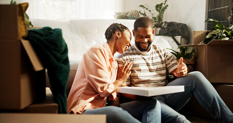 Pizza, moving and new house of black couple as happy home owners, relocation and eating on break. Man, woman and laughing with food or meal for talk, marriage and purchase of boxes in dream property