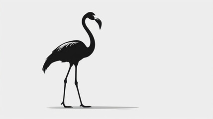 Fototapeta premium Elegant black silhouette of a flamingo standing gracefully on a light gray background.