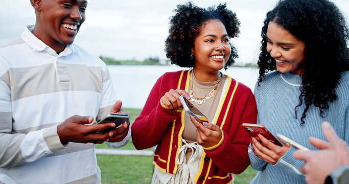 Phone, smile and social media with students outdoor at lake for college acceptance notification. Admission, app and good news with excited people in nature for university communication as friends - Powered by Adobe