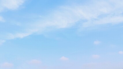 Beautiful scene of soft fluffy white clouds floating in a clear blue sky on a bright summer day,...