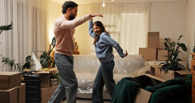 Love, moving and couple dance in new home to celebrate dream house or property investment. Man, woman and music for relocation goal, mortgage success and excited with energy for real estate at night