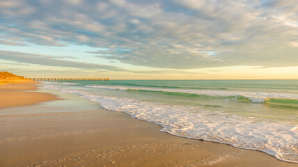 A stunning beach landscape photograph captured during golden hour.