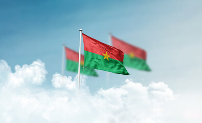 Burkina Faso national flags with mast waving in beautiful clouds. Burkina Faso flag for Republic Day and Independence Day.
