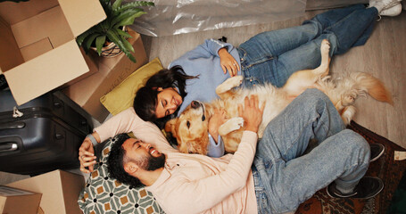 Couple, dog and relax on floor in new home for mortgage purchase, security and bonding together....