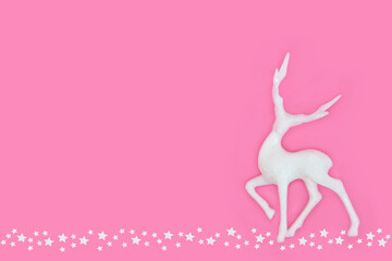 Fantasy reindeer Christmas Eve decoration with stars background. Magical white glitter bauble...