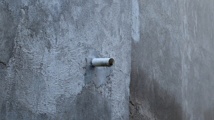 water pipe installed in gray wall