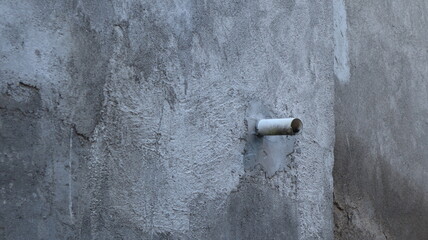 water pipe installed in gray wall