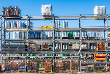 Bright and organized construction supplies stored on shelves under clear blue sky at a busy...