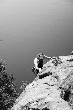 man climbing outdoors by the water in Sweden