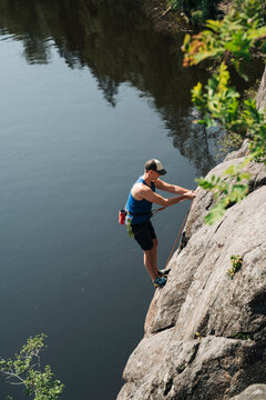 man rock climbing outdoors by the sea in Stockholm