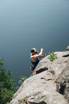 man rock climbing outdoors by the sea in Sweden